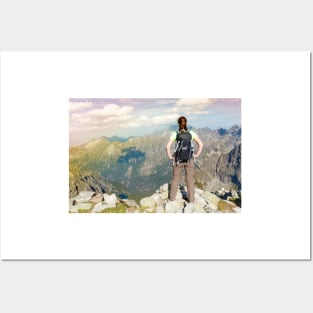 Woman with backpack standing on the edge, looking at mountains Posters and Art